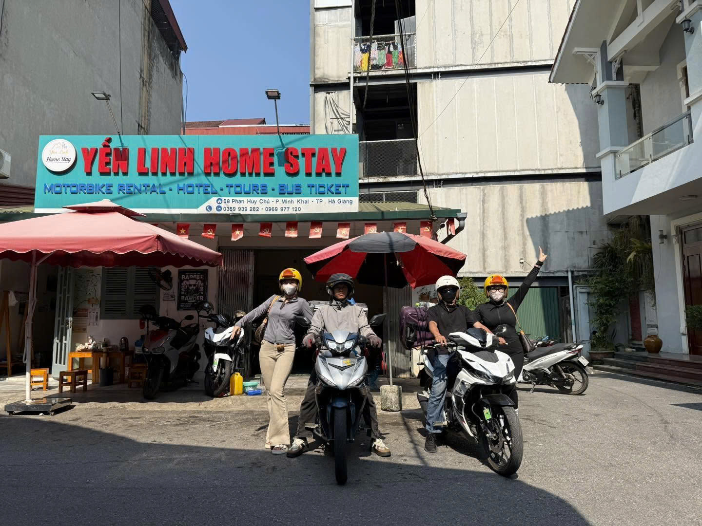 Local guide standing beside a motorcycle overlooking the deep canyons